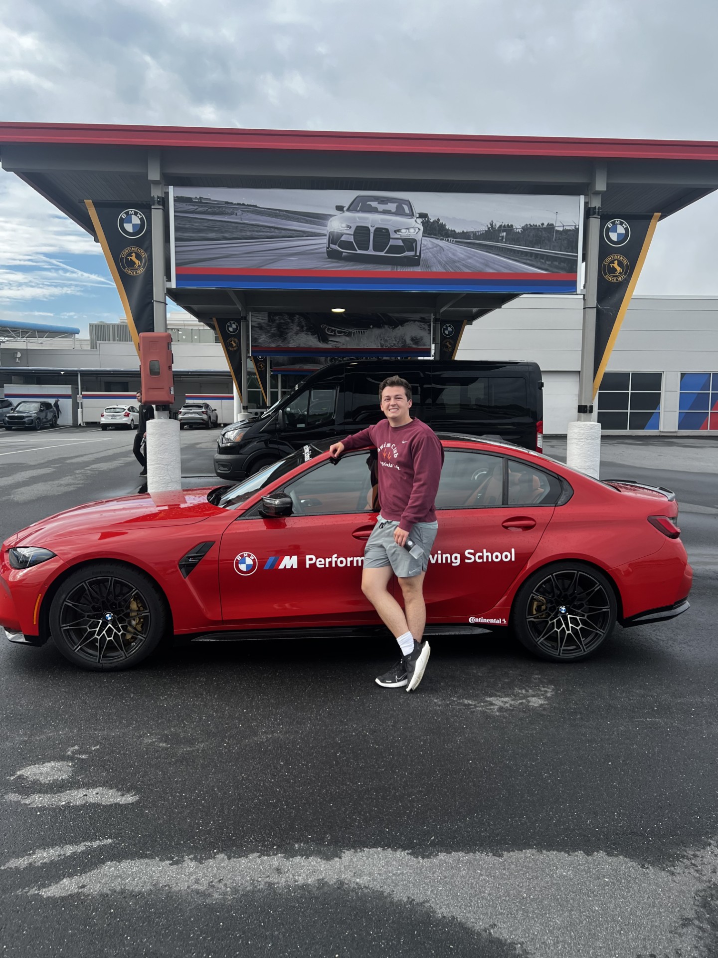 Charlie Steinman next to a BMW M3 at the BMW M Performance Driving School