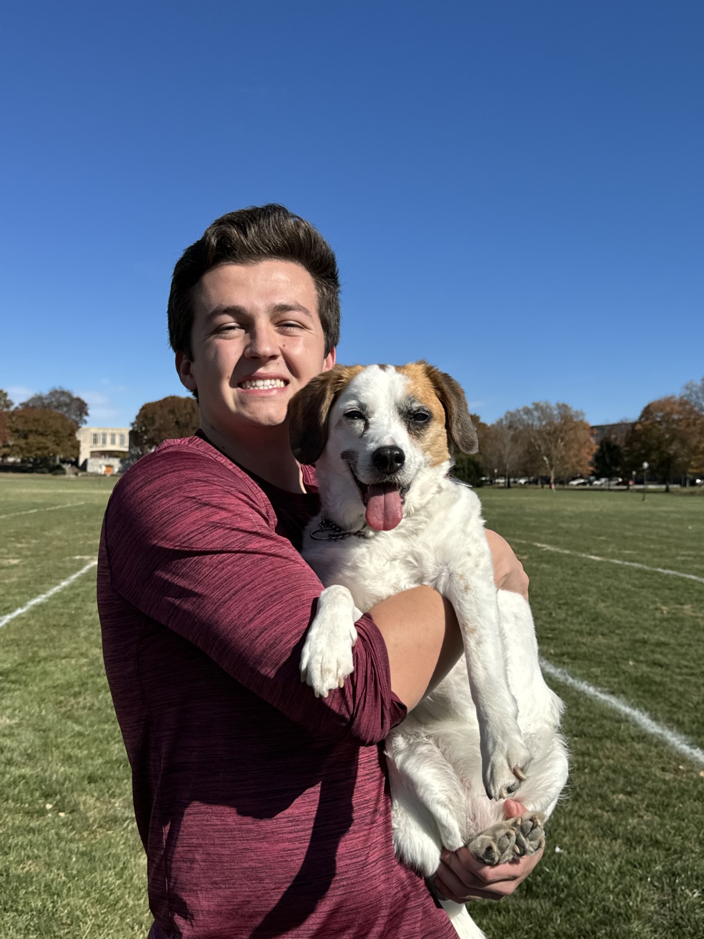Charlie Steinman holding his dog Molly on the Virginia Tech drillfield