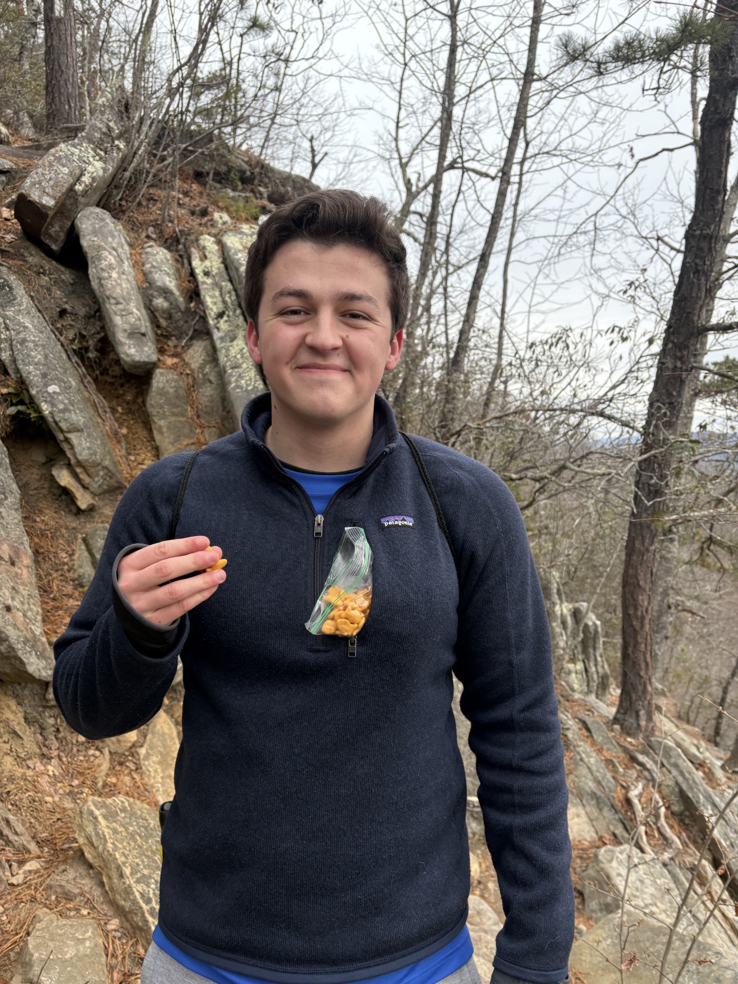Charlie Steinman hiking with a bag of trail snacks