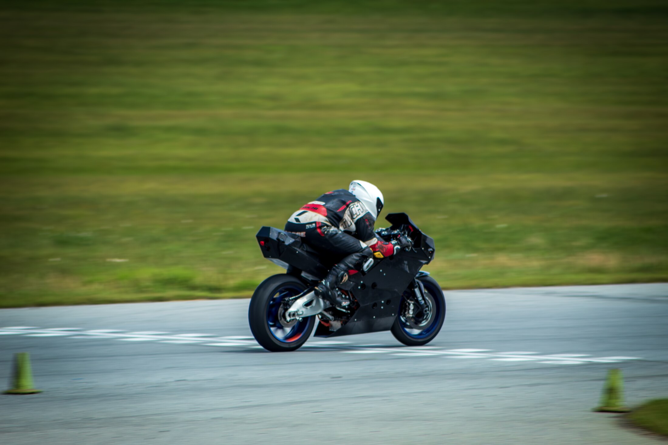 BOLT VI at speed on track, rider in full tuck