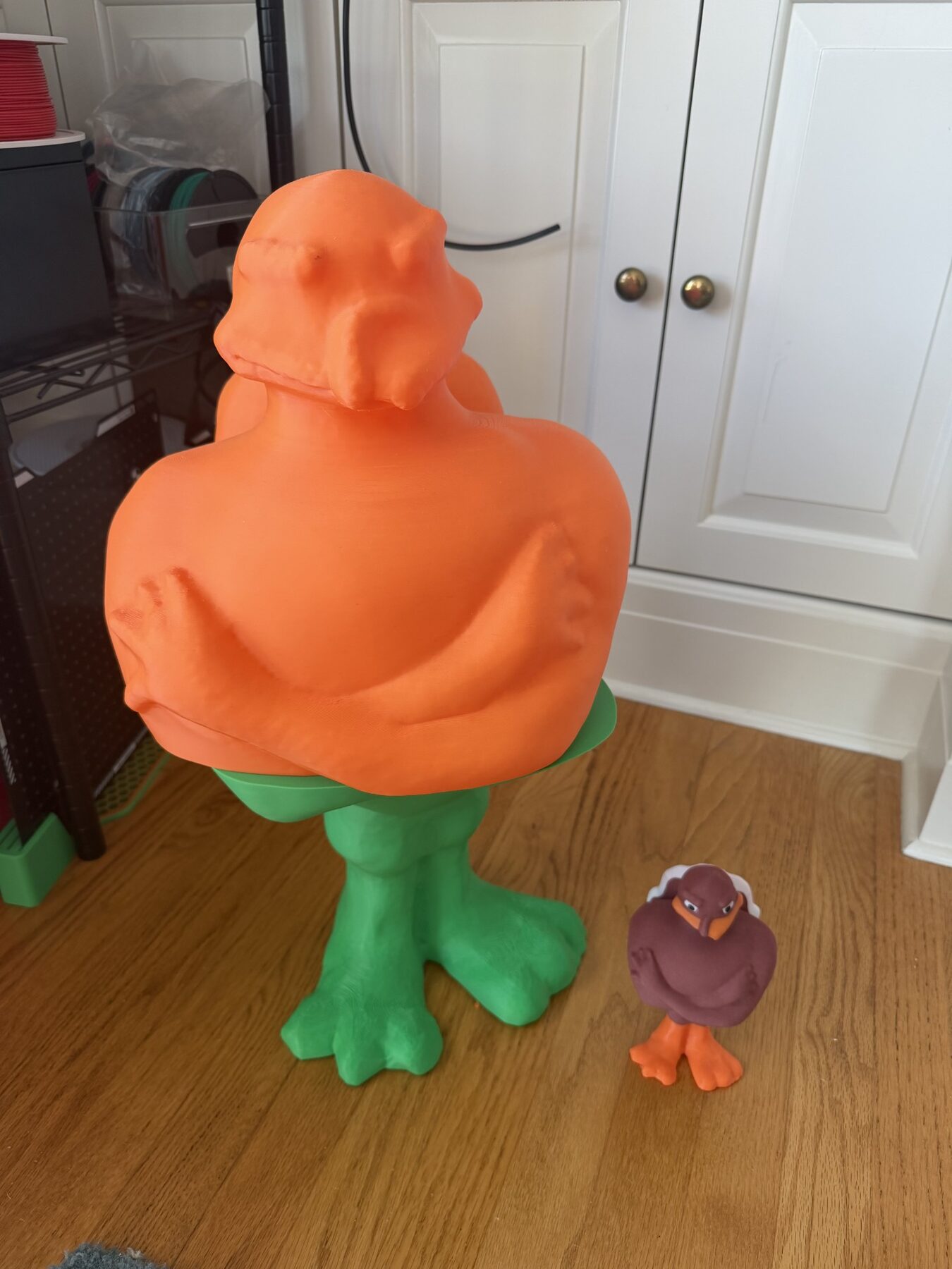 Scaled-up two-foot print next to an original-size statue for scale